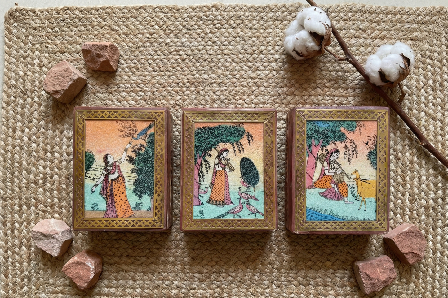 Small wooden jewelry box (assorted designs) framed with brass lattice work. Features colorful Indian miniature painting of royal figures and peacocks. Vintage style home decor.