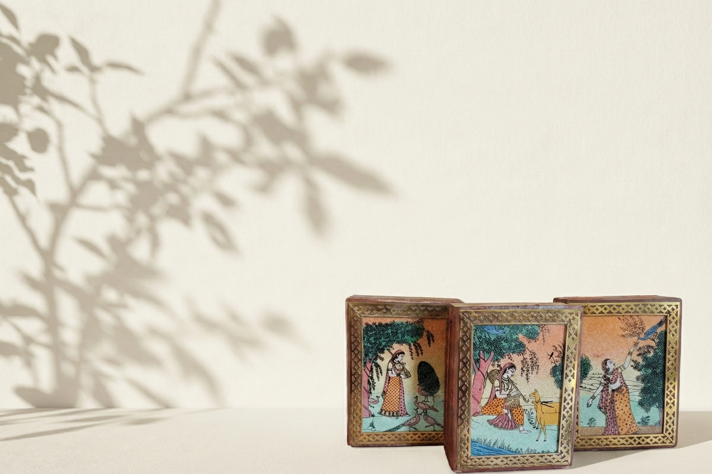 Small wooden jewelry box framed with brass lattice work. Features colorful Indian miniature painting.