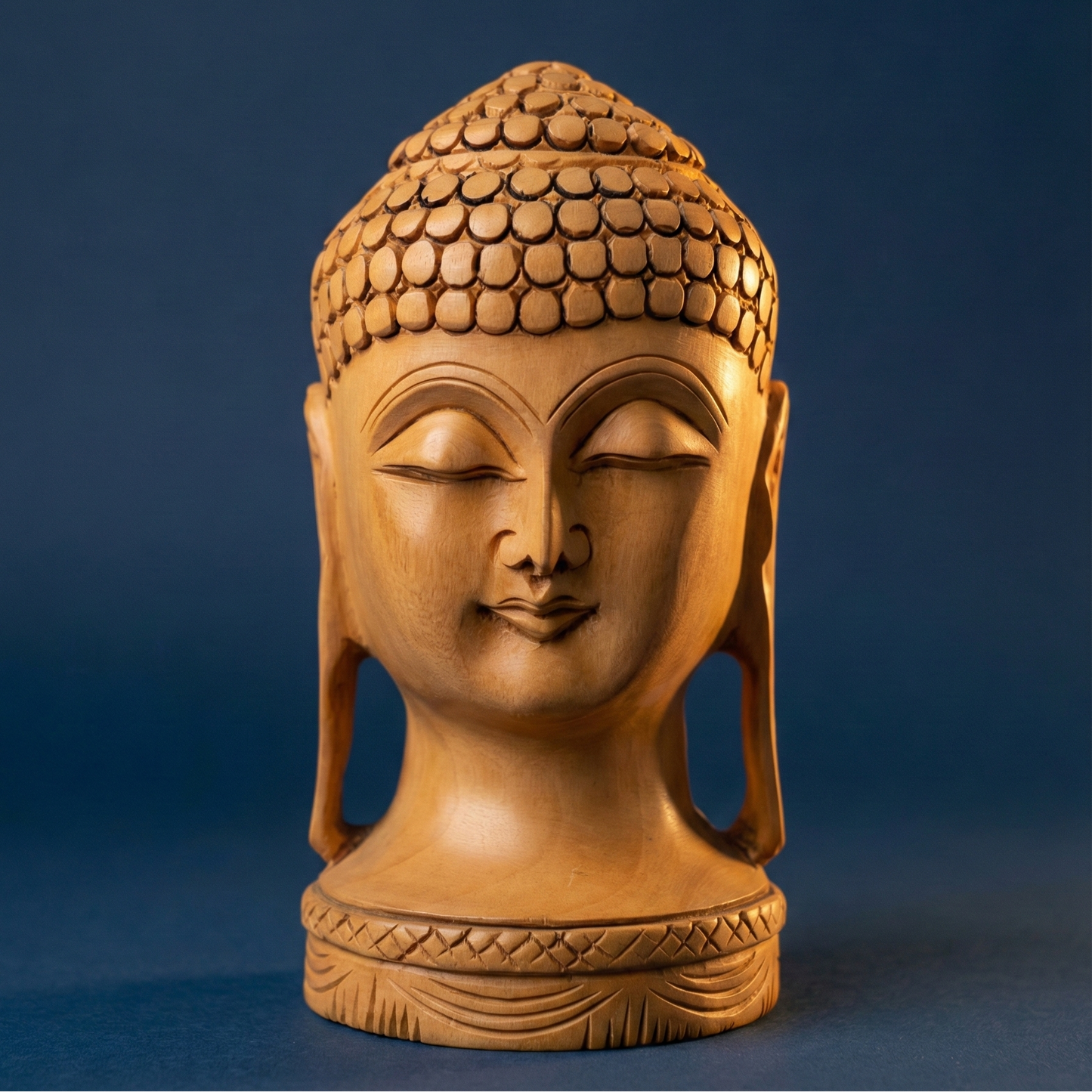 Hand-carved wooden Buddha head statue with natural polish for meditation and home decor.