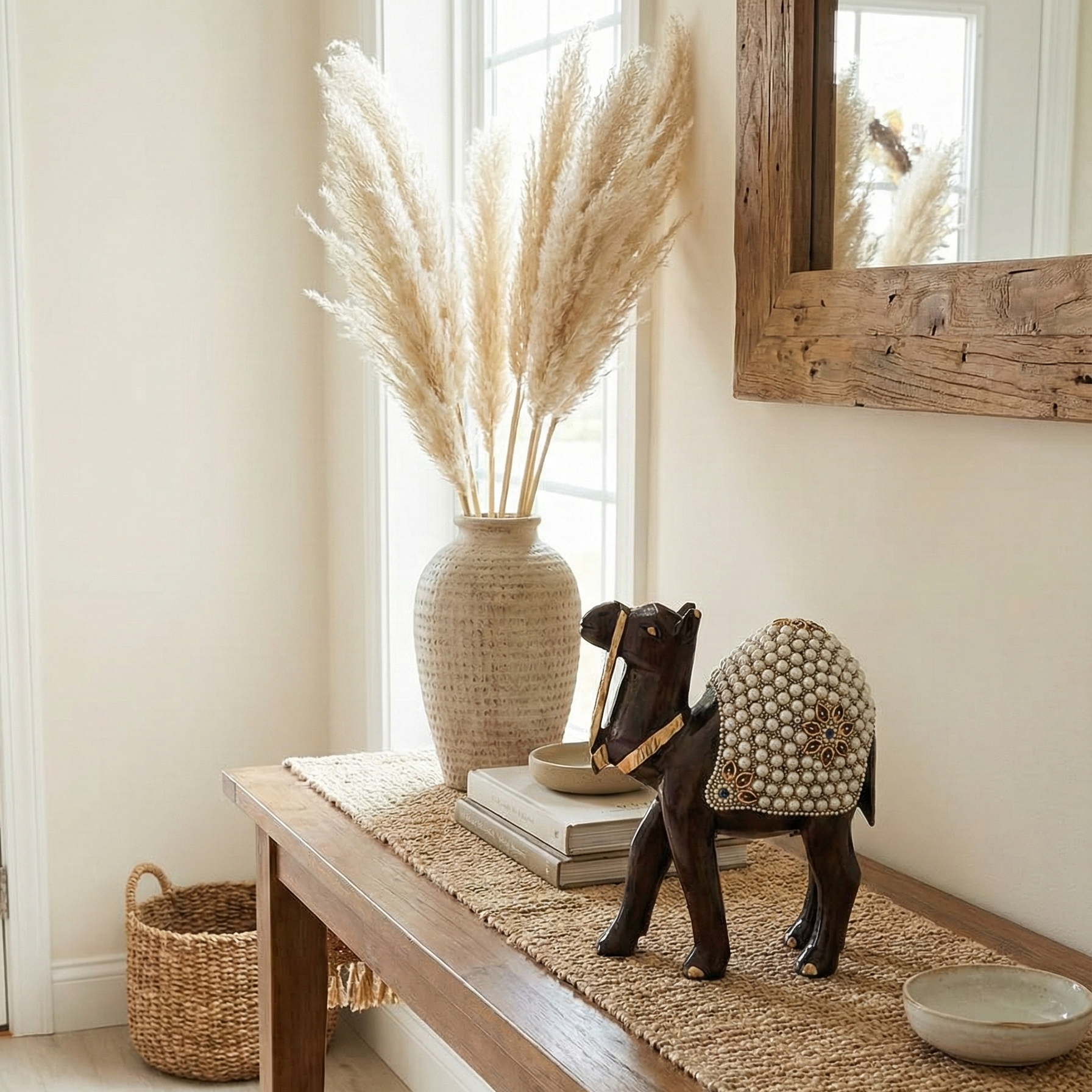 Hand-carved wooden camel figurine with pearl work placed on a wooden table near the House entrance