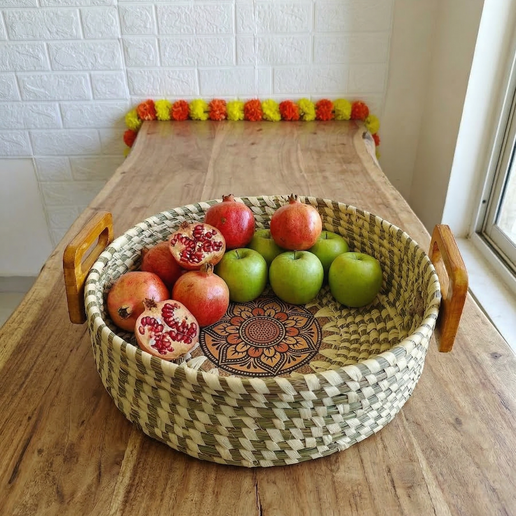 Handwoven natural Sabai grass Fruit basket with wooden handles and a decorative central mandala pattern.