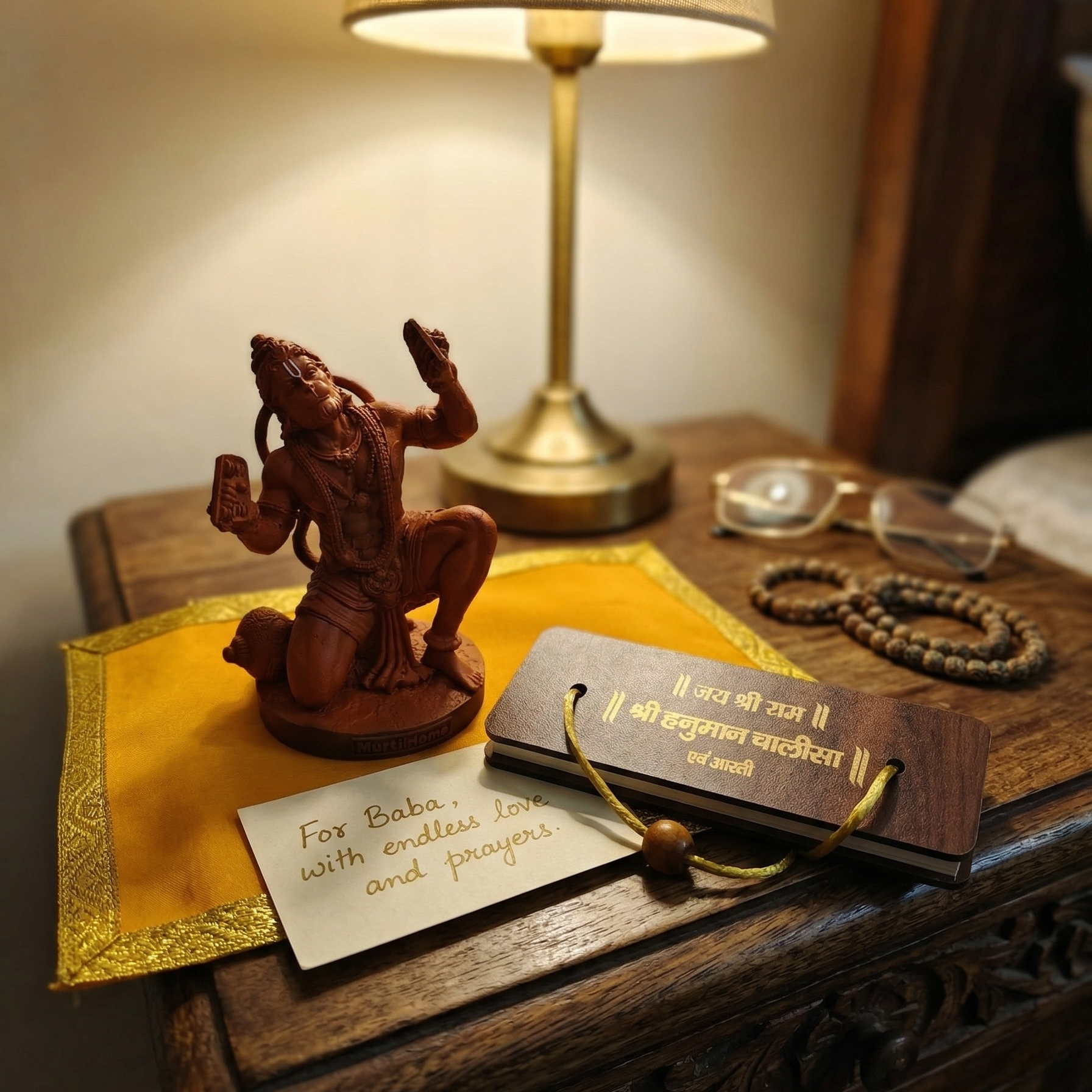 Terracotta-colored statue of Lord Hanuman with Hanuman Chalisa placed on the side table as gift 
