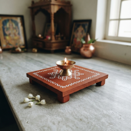 Kolam wooden manai with diya placed on it