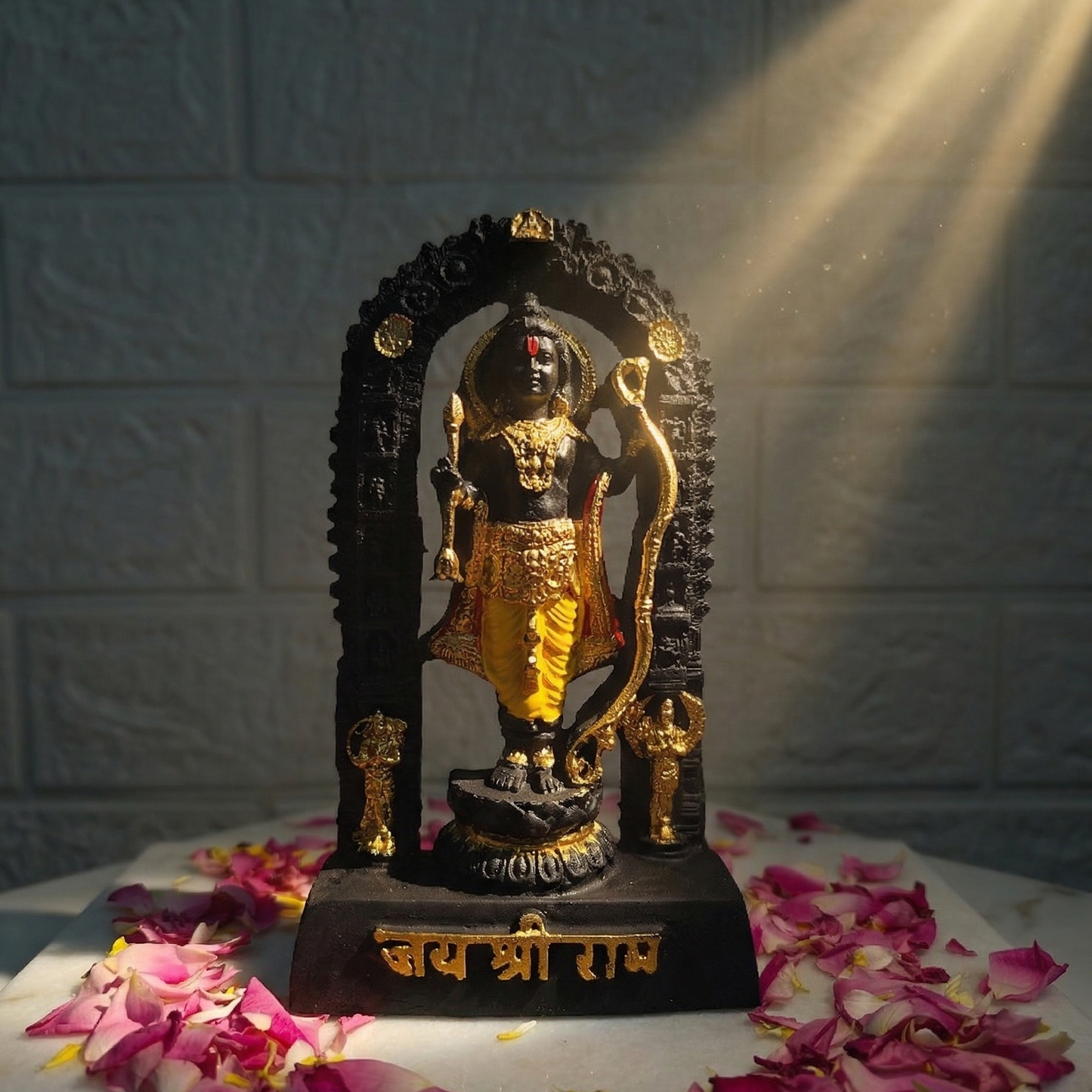 Sacred black Shri Ram Lalla murti standing inside an archway, richly adorned with golden jewelry and garments, with Jai Shri Ram inscribed on the base illuminated by sunlight
