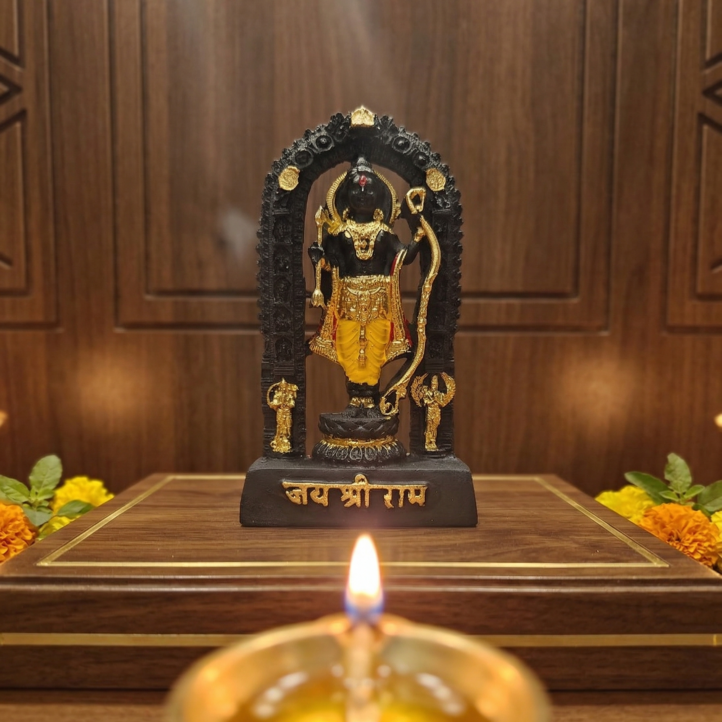 Sacred black Shri Ram Lalla murti standing inside an archway, richly adorned with golden jewelry and garments, with Jai Shri Ram inscribed on the base with diya lit infront of the idol and flowers on either side