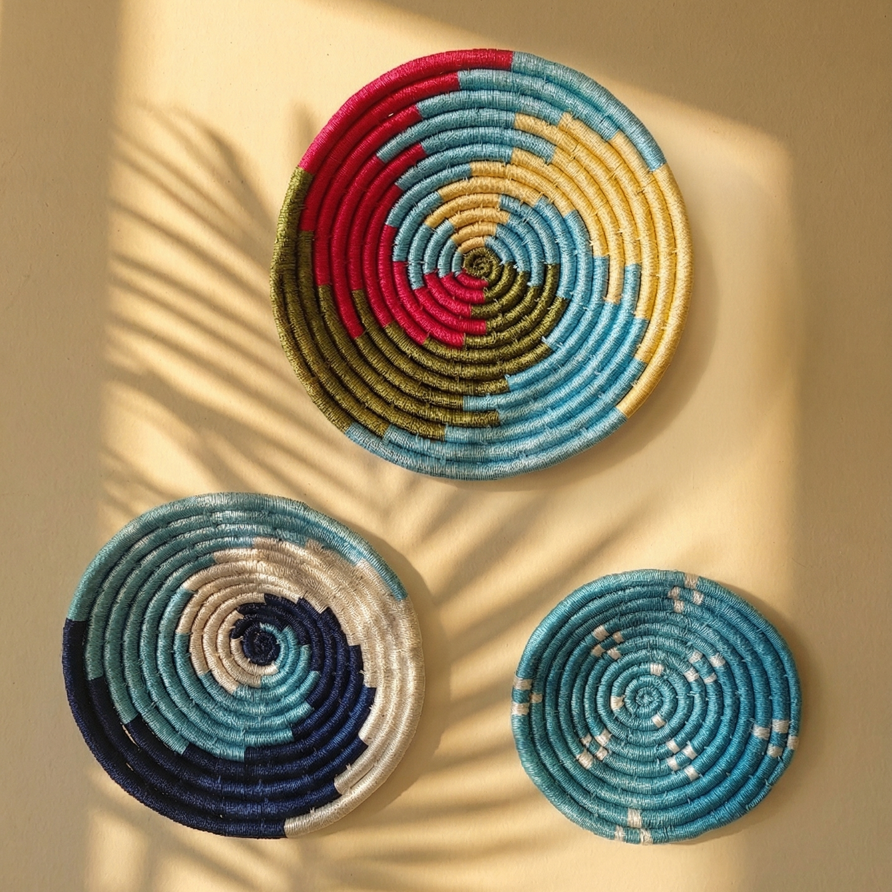 Set of assorted colorful Sabai grass handwoven baskets featuring vibrant geometric and spiral patterns sunkissed in the balcony