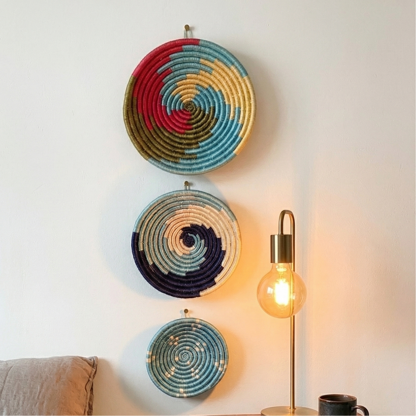 Set of assorted colorful Sabai grass handwoven baskets featuring vibrant geometric and spiral patterns placed near the bed side table