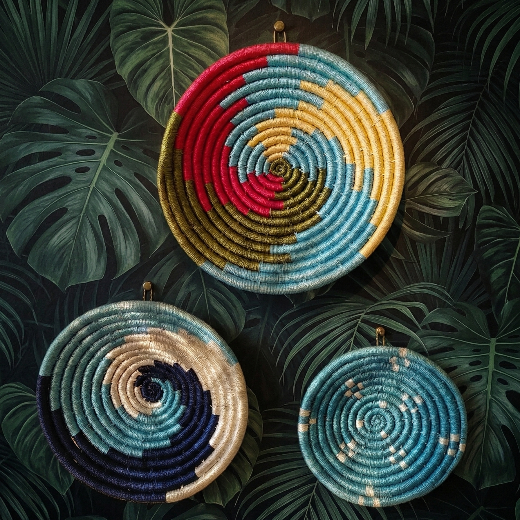 Set of assorted colorful Sabai grass handwoven baskets featuring vibrant geometric and spiral patterns on a printed wall