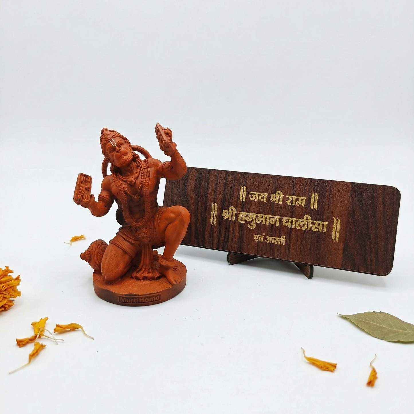 Sinduri Hanumanji Statue with Hanuman Chalisa in a white background with some flower petals