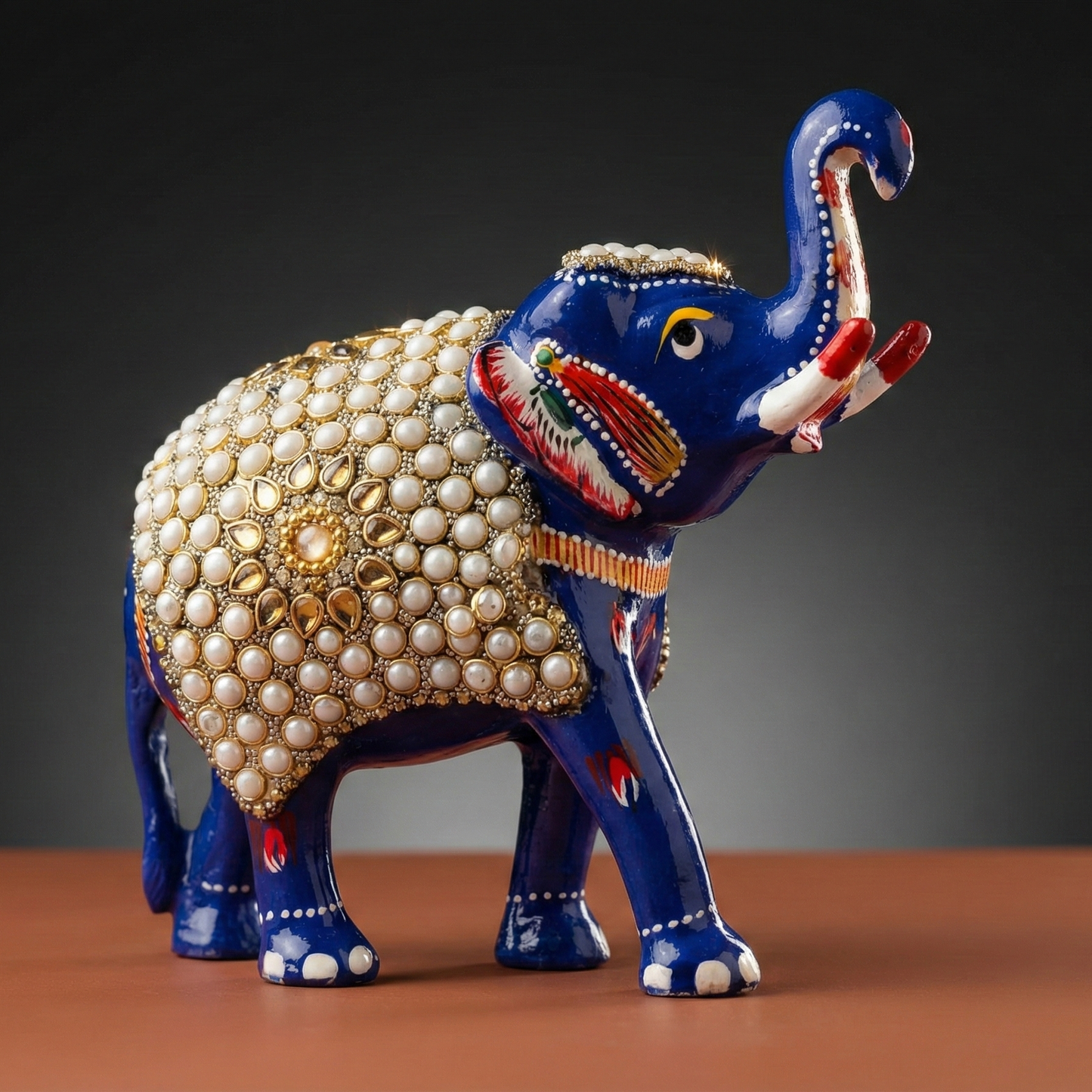 Handcrafted blue Meenakari elephant statue adorned with intricate white pearl and kundan work, standing in a side profile view.