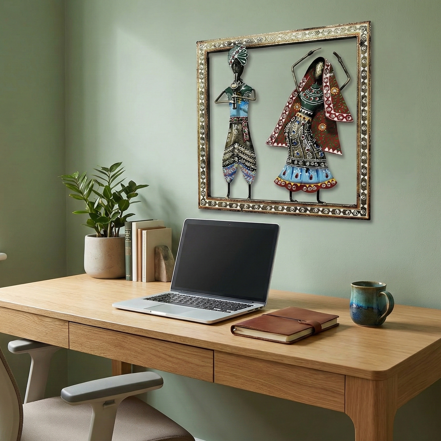 Kalbelia rhythm wall hanging placed above a study desk. Unique wrought iron ethnic accent piece for home offices and workspaces.