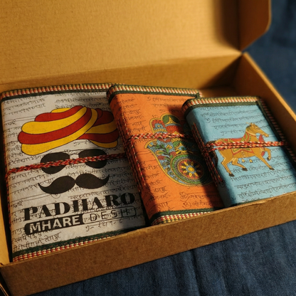 Set of 3 handmade eco-journals in a cardboard gift box. Features Padharo Mhare Des, Hamsa, and Horse designs. Perfect corporate gift or Indian souvenir