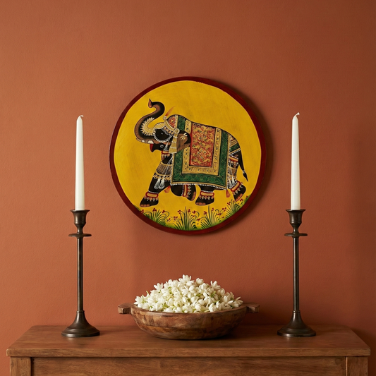Pichwai Hand-Painted Elephant Wall Plate styled with candles and flowers for traditional Indian home decor.
